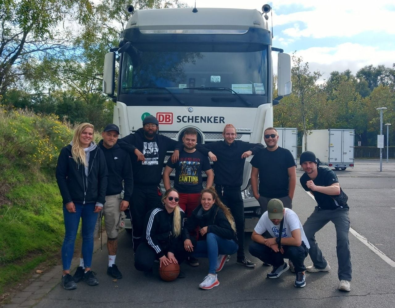 Sonnen Expo Logistics Team together with the team of DB Schenker in front of a lorry of DB Schenker.
